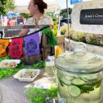 Photo by Emma Jane Garcia/Sequim Farmers & Artisans Market
Jamie Walkush greets visitors at the Jamies Green Cuisine booth at Sequim Farmers & Artisans Market.