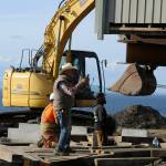 Sequim Gazette photo by Matthew Nash/ Homeowner Jim Nichols takes a video of crews moving his home away from a Dungeness hillside on Sept. 16. Over 30 years, the home went from about 100 feet away from the hillside to about 30 feet.
