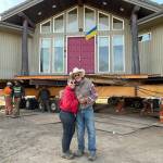 Sequim Gazette photo by Matthew Nash
Jim Nichols and Natasha Merkuloff stand by their front door as Nickel Bros crewmen make the final move forward with their home away from a Dungeness bluff side on Sept. 16.