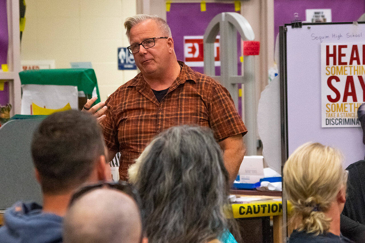 Sequim Gazette photo by Emily Matthiessen / Det. Sgt. Darrell Nelson speaks to attendees of a joint safety forum hosted by Sequim Police Department and Sequim School District on Sept. 14 in the Sequim High School Library. Law enforcement said they initially treated graffiti found on Sept. 4 as a high level threat but now believe it to be a low level threat and more vandalism than a threat likely from students.