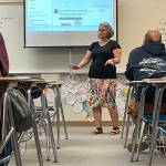 Sequim Gazette photo by Matthew Nash/ Cheryl Eekhoff welcomes families of her seventh-grade accelerated English Language Arts class during Back to School Night in Sequim Middle School.