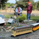 Sequim Gazette photo by Matthew Nash/ Dick Wolf of Sequim chats with Alan Melrose of Kent during a club tour of Wolf’s garden railroad for the Puget Sound Garden Railway Society on Sept. 17. Wolf and his wife Evelyn started with G-scale (garden) trains in 1999 after discovering a magazine about the hobby, Dick said.