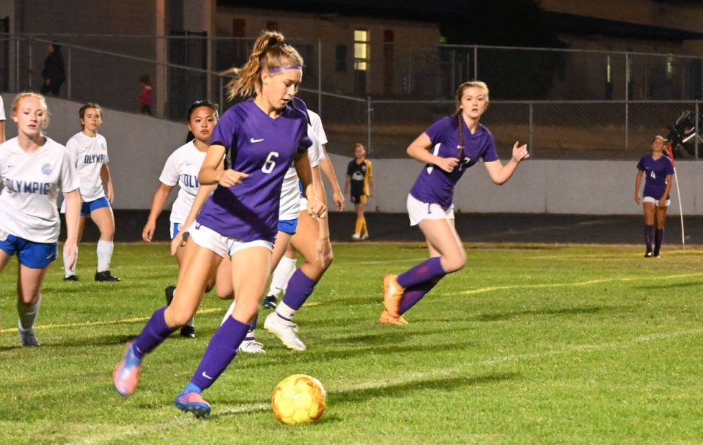 Sequim Gazette photo by Michael Dashiell / Sequim Highs Teagen Moore, left looks for a teammate as Sequims Eve Breithaupt looks in early in the second half of the Wolves 6-1 win over Olympic on Sept. 20.