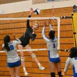 Sequim Gazette photo by Michael Dashiell / Sequim senior Kendall Hastings looks to hit past Olympics Erika Caryharius, left, and Aviyah Blackwell in a league match-up on Sept. 20.
