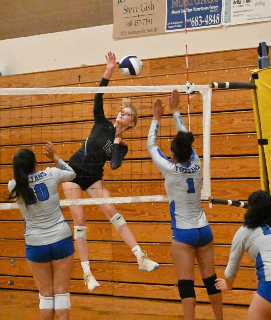 Sequim Gazette photo by Michael Dashiell / Sequim senior Kendall Hastings looks to hit past Olympics Erika Caryharius, left, and Aviyah Blackwell in a league match-up on Sept. 20.