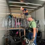 Sequim Gazette photo by Matthew Nash/ Roger Gilchrist and Roger Dickson meticulously place walkers inside a tractor-trailer on Sept. 20 headed for Kentucky before being shipped to Guatemala to help people with mobility issues. Organizers with Dungeness Community Church hope the supplies can reach people by Thanksgiving.