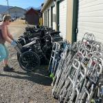 Sequim Gazette photo by Matthew Nash/ Jackie Ragghianti helps fellow Dungeness Community Church attendees organize wheelchairs, walkers and more on Sept. 20 at All-Safe Mini-Storage to be shipped to Guatemala to help people with mobility issues.