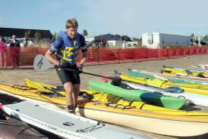KEITH THORPE/PENINSULA DAILY NEWS
Ian Mackie of Gig Harbor prepares to launch his kayak from Pebble Beach as an iron man competitor during Saturday's Big Hurt in Port Angeles.