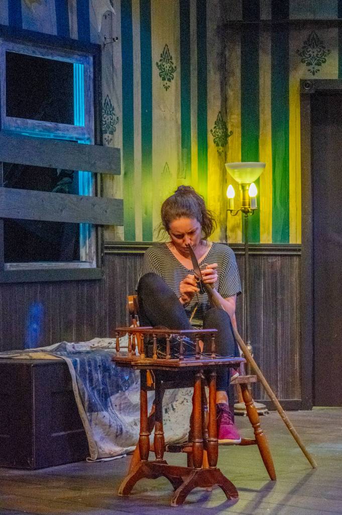 Sequim Gazette photo by Emily Matthiessen / Nikki Mischke, as Barbara, works on an improvised weapon during a rehearsal for OTA's production of Night of the Living Dead.