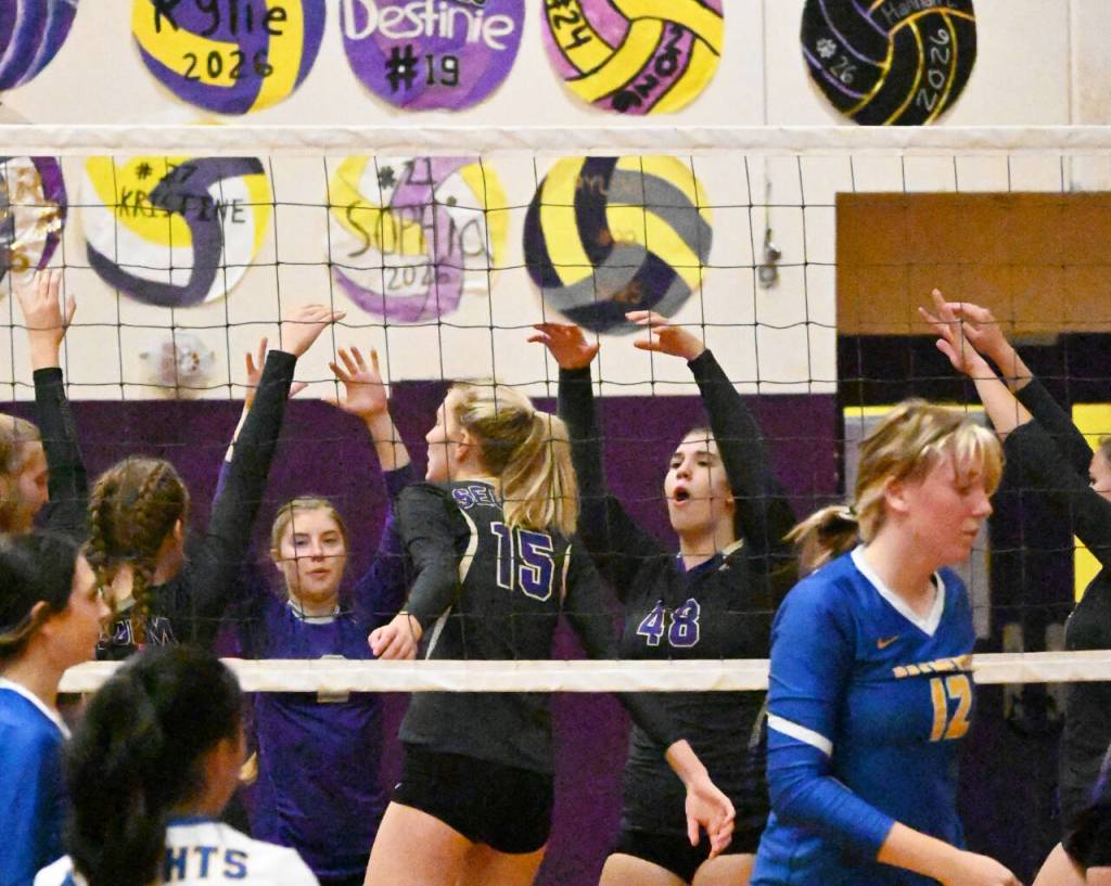 Sequim Gazette photo by Michael Dashiell / Sequim teammate celebrate a big block by senior Kendall Hastings (15) in a straight set win over Bremerton on Sept. 29.