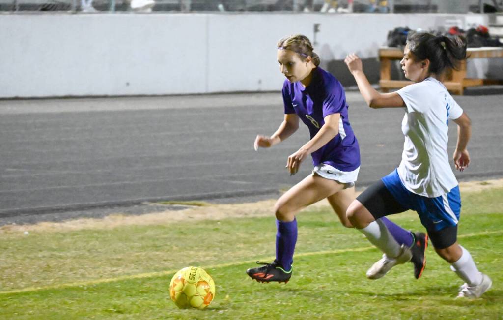 Sequim Gazette photo by Michael Dashiell / Sequim freshman midfielder Kiley Winter, left, drives deep into Bremerton territory in the second half of the Wolves 4-0 win over Bremerton oN Sept. 29.