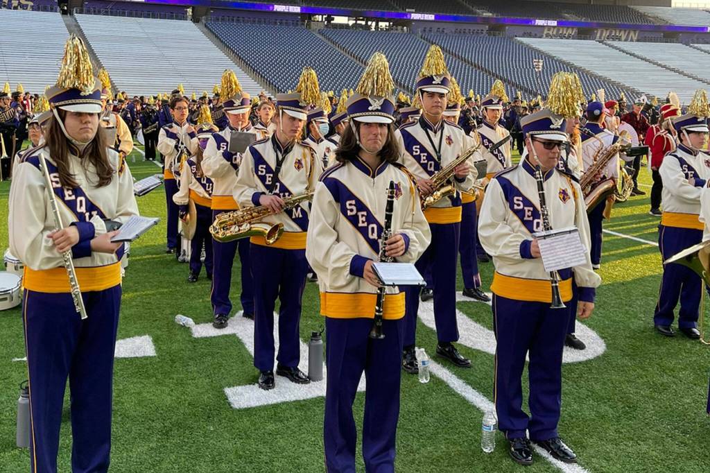Submitted photo/ Sequim High and Middle School students rehearse for the halftime show of the University of Washingtons football game on Sept. 10 with more than 2,000 other students from across Washington.