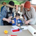 Photo by Keith Thorpe/Olympic Peninsula Daily News Group / Kaine Lamb, 4, makes an ink print with the assistance of his mother, Carlie Lamb of Port Angeles, right, and Jan Dove of the Port Angeles Fine Arts Center. Print-making was a featured childrens event during Peninsula Colleges Fall Spectacular on the schools Port Angeles campus on Oct. 1. The event, hosted by the school to bring the community to the campus, also featured displays and demonstrations, tethered balloon rides, food and music.