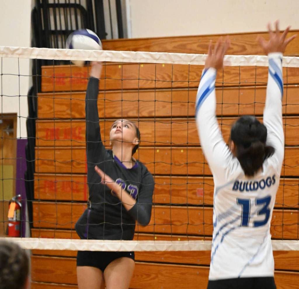 Sequim Gazette photo by Michael Dashiell / Sequims Arianna Stovall hits past blocker Adianna Tupolo in the Wolves four-set home win over North Masons Bulldogs on Sept. 6.