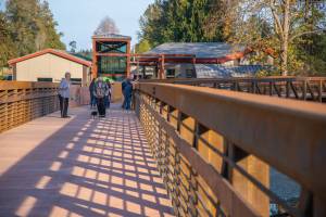 Sequim Gazette photo by Emily Matthiessen 
Pedestrians and bicyclists last week check out the newly-reopened bridge at Railroad Bridge Park, part of the Olympic Discovery Trail.