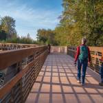 Sequim Gazette photo by Emily Matthiessen 
Pedestrians and bicyclists last week check out the newly-reopened bridge at Railroad Bridge Park, part of the Olympic Discovery Trail.