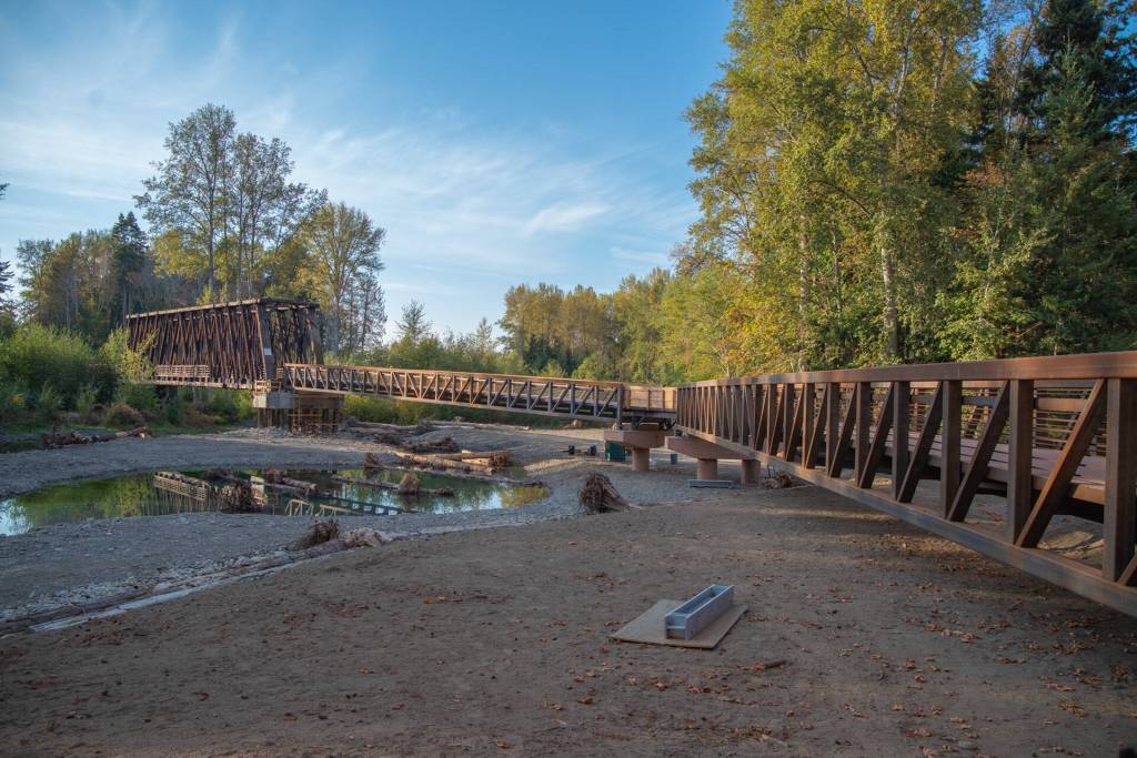Sequim Gazette photo by Emily Matthiessen 
Pedestrians and bicyclists last week check out the newly-reopened bridge at Railroad Bridge Park, part of the Olympic Discovery Trail.