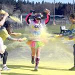 Michael Dashiell/Olympic Peninsula News Group
Tiffanie Powless gets a splash of yellow at the last color station at the Sun Fun Color Run 5k Saturday morning at the Albert Haller Playfields just north of Carrie Blake Community Park in Sequim. More than 500 participants were registered to run/walk 5k and 1k races, which were among the events offered during the third annual Sunshine Festival on Friday and Saturday.
