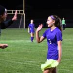 Sequims Taryn Johnson gets a high-five from assistant coach Dave Breckenridge after a five-goal effort against North Mason on Oct. 6. Johnson set the school record for career goals in the process.