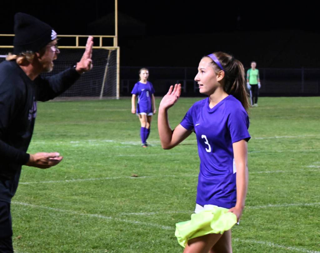 Sequims Taryn Johnson gets a high-five from assistant coach Dave Breckenridge after a five-goal effort against North Mason on Oct. 6. Johnson set the school record for career goals in the process.