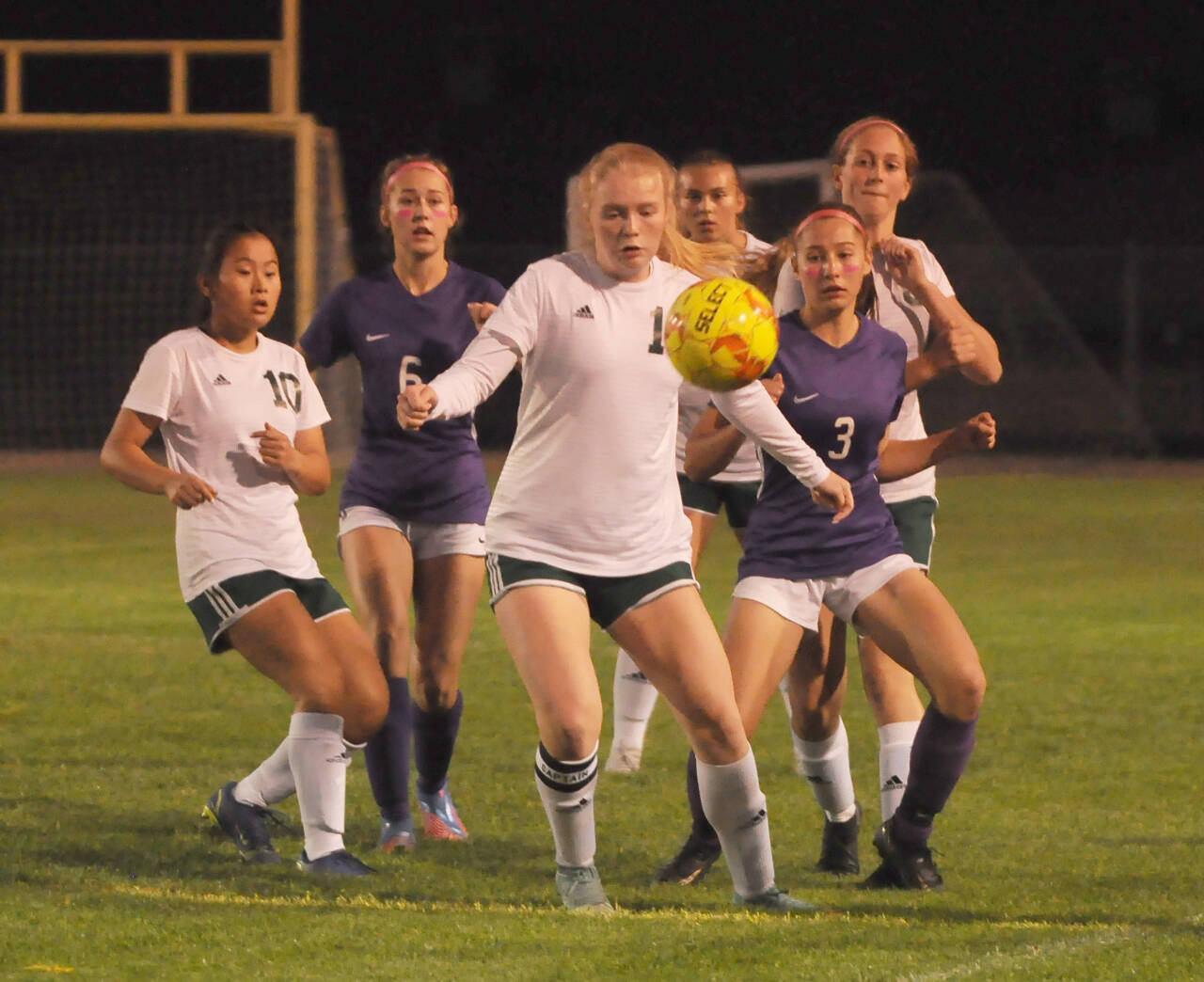 Michael Dashiell/Sequim Gazette
Port Angeles Paige Mason, center looks to control the ball as, from left, Port Angeles Lily Sanders (10) and Sequims Teagen Moore (6) and Taryn Johnson (3) look on in an Olympic League match on Oct. 11. Port Angeles edged their rivals, 3-2.