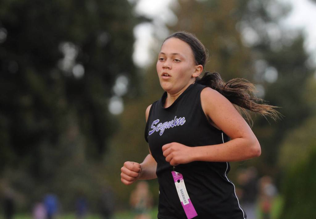 Sequim Gazette photo by Michael Dashiell / Sequim High sophomore Liberty Mavy places 12th at the Olympic League cross country championships on Oct. 20, helping the Wolves place third overall and qualify as a team for the West Central District meet.