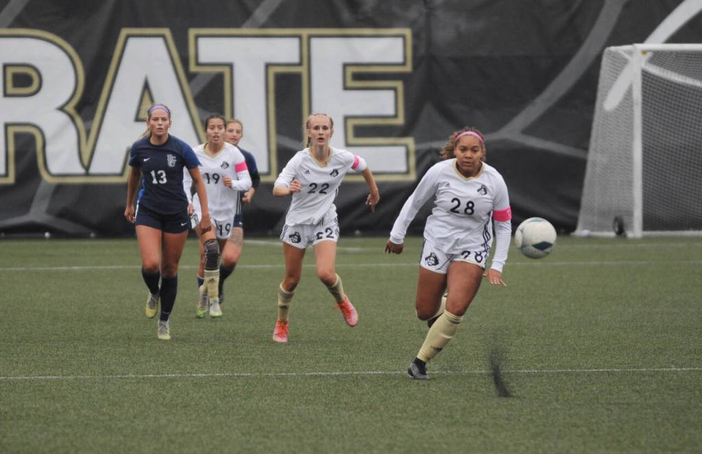 Sequim Gazette photo by Michael Dashiell / Peninsulas Kiarra Scheib (28) advances the ball downfield in the second half of a 6-0 PC win over visiting Bellevue on oct. 26. Looking on are teammates Hannah Wagner (22), a Sequim High grad, and Kira Meechudhone (19).