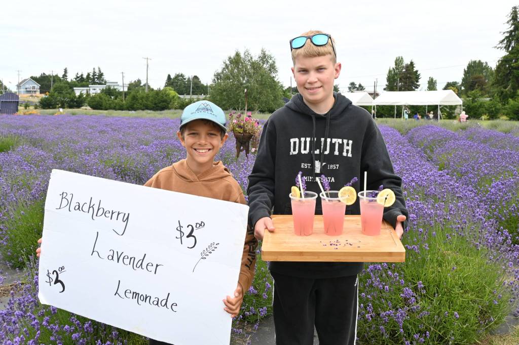 Sequim Gazette photo by Michael Dashiell / River Moslui-Horgan, left, and Caleb Millet sell lavender lemonade at In Bloom Lavender Farms on July 17.