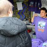 Sequim Gazette photo by Matthew Nash/ June Nicholas with the Sequim Valley Lions shows the design for the Sequim Lavender Festival T-shirt for patrons at the Street Fair on July 16.