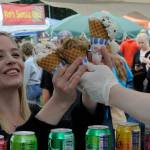 Sequim Gazette photo by Matthew Nash/ Sara Turner of Sequim readies to take four ice cream cones from Olympic Mountain Ice Cream to her family at the Sequim Lavender Festival Street Fair on July 16.