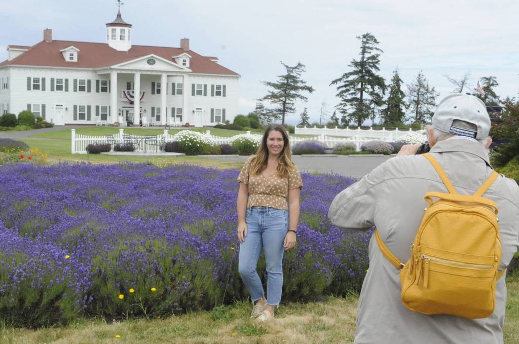 Sequim Gazette photo by Matthew Nash/ Tess Arnold of Seattle has her photo taken at Washington Lavender/George Washington Inn during a tour on July 17. Arnold is a travel blogger at <a href="https://travelingtessie.com" target="_blank">travelingtessie.com </a>and said she planned to visit several farms on Sunday after searching for new things to do in Washington.