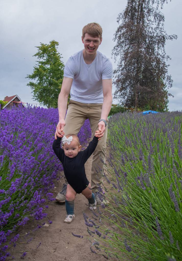Sequim Gazette photo by Emily Matthiessen / Landon Anderson receives a walk through the Purple Haze Lavender Farm from his daughter Rose. The Anderson family traveled from Puyallup for the festival.