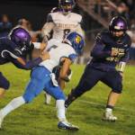 Sequim Gazette photo by Michael Dashiell / Sequims Saul Williams, left, and Ayden Holland tackle Bremerton running back Jayden Quenga in the first half of an Oct. 28 Olympic League game.