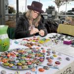 PHOTO BY Keith Thorpe/Olympic Peninsula News Group
Sharon Prosser of Sequim creates refrigerator magnets with hand-painted rocks as part of the Ladybug Project, a fund-raising effort for the Olympic Peninsula Humane Society. Prosser was making and selling magnets for $1 each and taking monetary donations to the society on Oct. 22 at the Port Angeles Farmers Market.