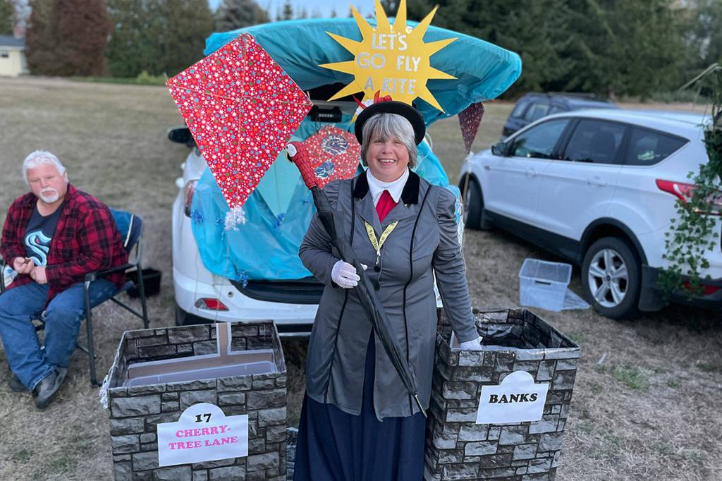 Sequim Gazette photo by Matthew Nash/ Along with pumpkins, cookies and hot dogs, visitors to the Sequim Prairie Grange could visit various themed-trunks, including Heather Ceruttis version of Mary Poppins, for candy. Other trunks ranged from an Elvis-theme to Jurassic Park.