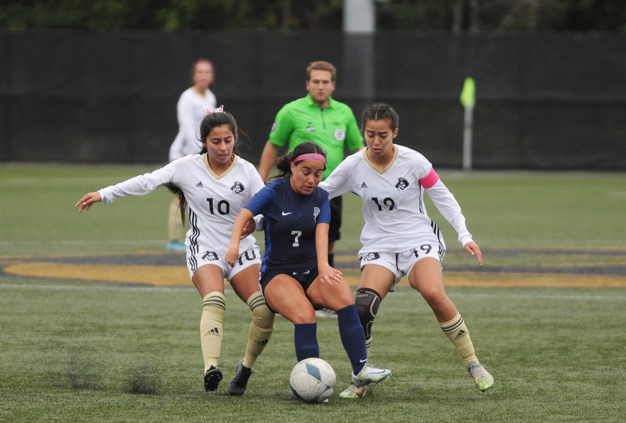 Sequim Gazette photo by Michael Dashiell / Peninsulas Maylin Rivera, left, and Kira Meechudhone vie for the ball against Bellevues Samantha Corrales in the second half of a 6-0 PC home win on Oct. 26.