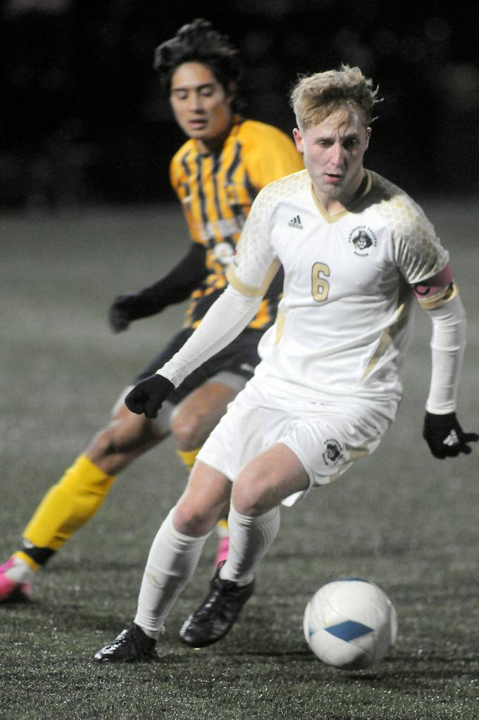 Photo by Keith Thorpe/Olympic Peninsula News Group / Peninsulas Tim Deser drives across the pitch followed by Walla Wallas Julio Tapia on Nov. 5 in Port Angeles.