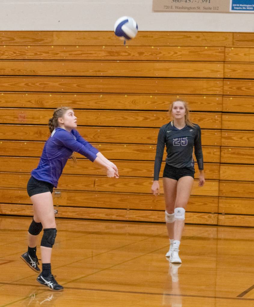 Sequim Gazette photo by Emily Matthiessen / As Jolene Vaara looks on, Sequim libero Mia Coudriet passes to a teammate in the Wolves three-game sweep of Port Angeles on Nov. 3.