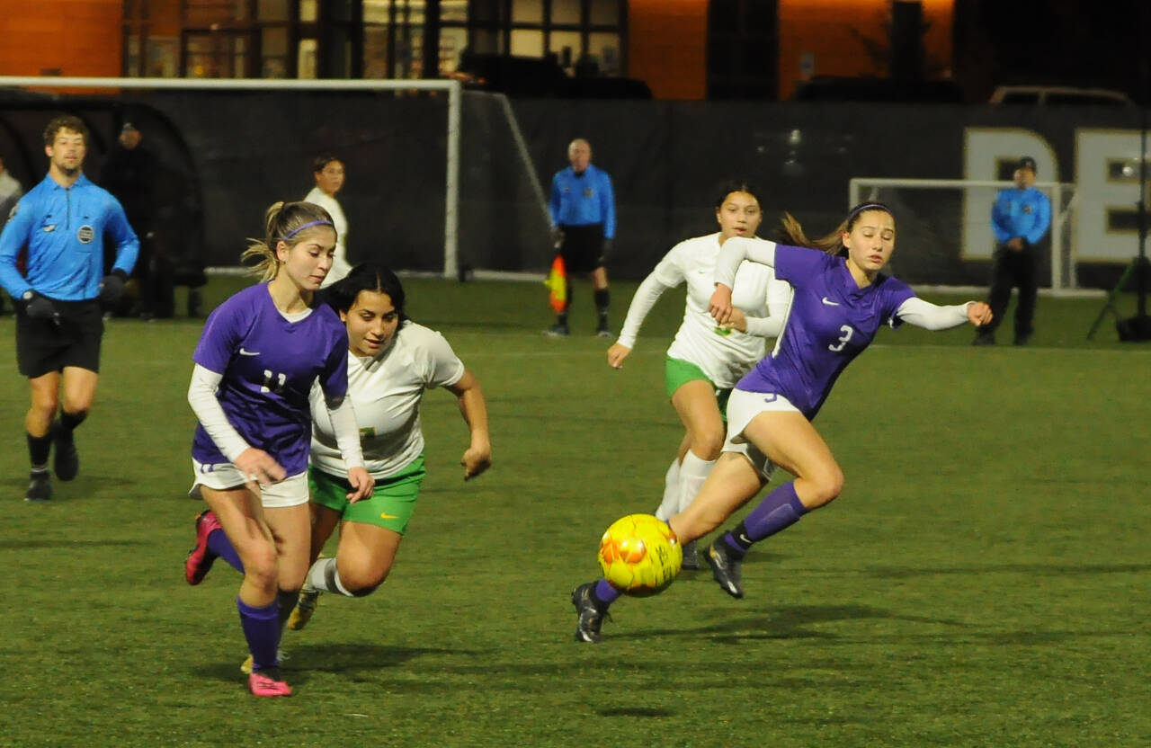 Sequim Gazette photos by Michael Dashiell 
Above: Sequims Alliyah Weber, left, and Taryn Johnson advance the ball into Clover Park territory in the Wolves 2-0 win in the opening round of the West Central District tourney on Nov. 1.
At right: Sequims Jennyfer Gomez, left, battles with a Clover Park midfielder in the Wolves 2-0 win