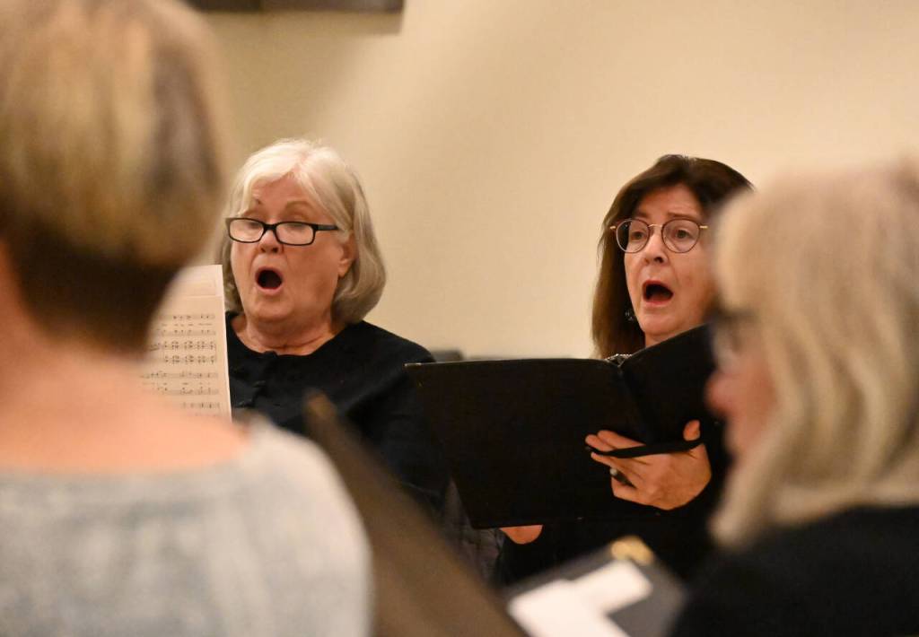 Sequim Gazette photo by Michael Dashiell / Peninsula Singers Patty Shoop, left, and Andria Richey rehearse for the groups fall concert, set for Nov. 12-13 at Dungeness Valley Lutheran Church.