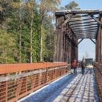 Sequim Gazette photo by Emily Matthiessen/ Visitors walk the Dungeness River Railroad Bridge on Tuesday, Nov. 8, amid melting snow that fell starting the evening before.