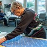 Sequim Gazette photo by Emily Matthiessen / Betty Zander prepares a piece of flannel fabric for cutting to be made into blankets by the Sequim Serger Squad, , which is seeking new volunteers and donations in their quest to provide blankets to children locally and globally.