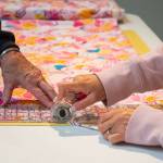 Sequim Gazette photo by Emily Matthiessen / Betty Zander and Julianne Coonts work together to cut fabric for blankets for children in need. Zander and Coonts are two members of the Sequim Serger Squad, which is seeking new volunteers and donations in their quest to provide blankets to children locally and globally.