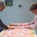 Sequim Gazette photo by Emily Matthiessen / Sequim Gazette photo by Emily Matthiessen / Betty Zander and Julianne Coonts work together to cut fabric for blankets for children in need. Zander and Coonts are two members of the Sequim Serger Squad, which is seeking new volunteers and donations in their quest to provide blankets to children locally and globally.