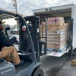 Sequim Gazette photo by Matthew Nash/ Josh Forberg, safety and logistics coordinator for Sequim Food Bank, unloads 1,200 pumpkin pies from Safeway on Nov. 10 that will be provided during the Holiday Meal Bags Distribution event on Nov. 18 in Carrie Blake Community Park.
