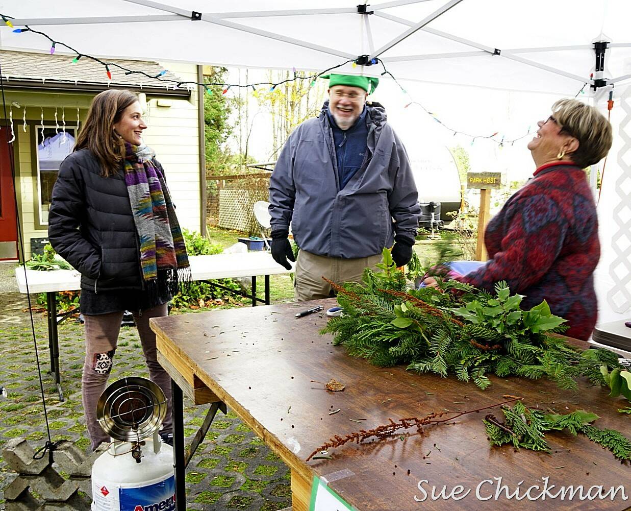 Submitted photo / Tuttie Peetz, right, brings her wreath-making equipment and piles of greens, cones and ribbons to the River Center Holiday Nature Mart this weekend. This sale of hand-crafted items, holiday wreaths and arrangements, and baked goods and candy, set for Nov. 19-20, support the Dungeness River Nature Center’s education programs.