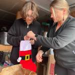 Sequim Gazette photo by Matthew Nash/ River Jensen, left, and her mom Anna Larsen say donations of toiletries are down this year for Rivers Christmas Project to supply stockings with toiletries, gloves, winter hats and more. They plan to supply the stockings to local agencies prior to Christmas.