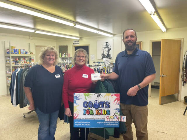 Submitted Photo
Coats For Kids organizers Karen Lewis and Heidi Albrecht present Levi Douglas, Clallam County Veterans Program Coordinator, with more than $1,200 worth of certificates for veterans at the Northwest Veterans Resource Center.