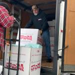 Sequim Gazette photo by Matthew Nash/
Jeff McFarland helps Gary Dills unload boxes of toys to be sorted for local agencies and families through Toys for Tots this Christmas.