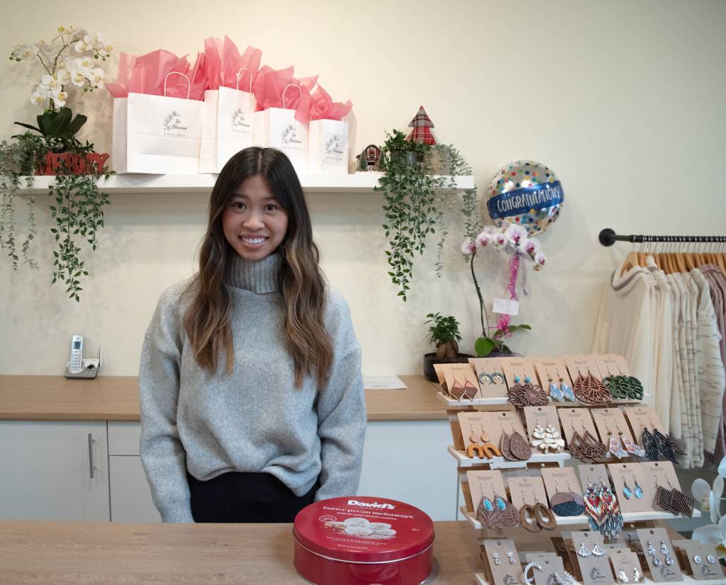 Sequim Gazette photos BY Emily Matthiessen
Amanda Hes shop Be Blossom Boutique holds its grand opening at the end of November. The earrings to the right of He are large but light, and behind are some of the blooming orchids that grace the shop.